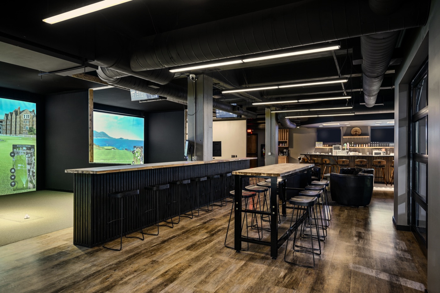 Golf bays and seating inside The Hideout at Sylvan Supply